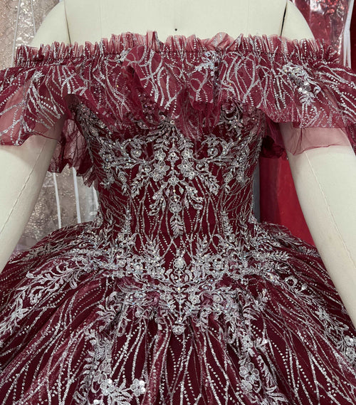 A beautiful gown, off-shoulder, reveals noble air.