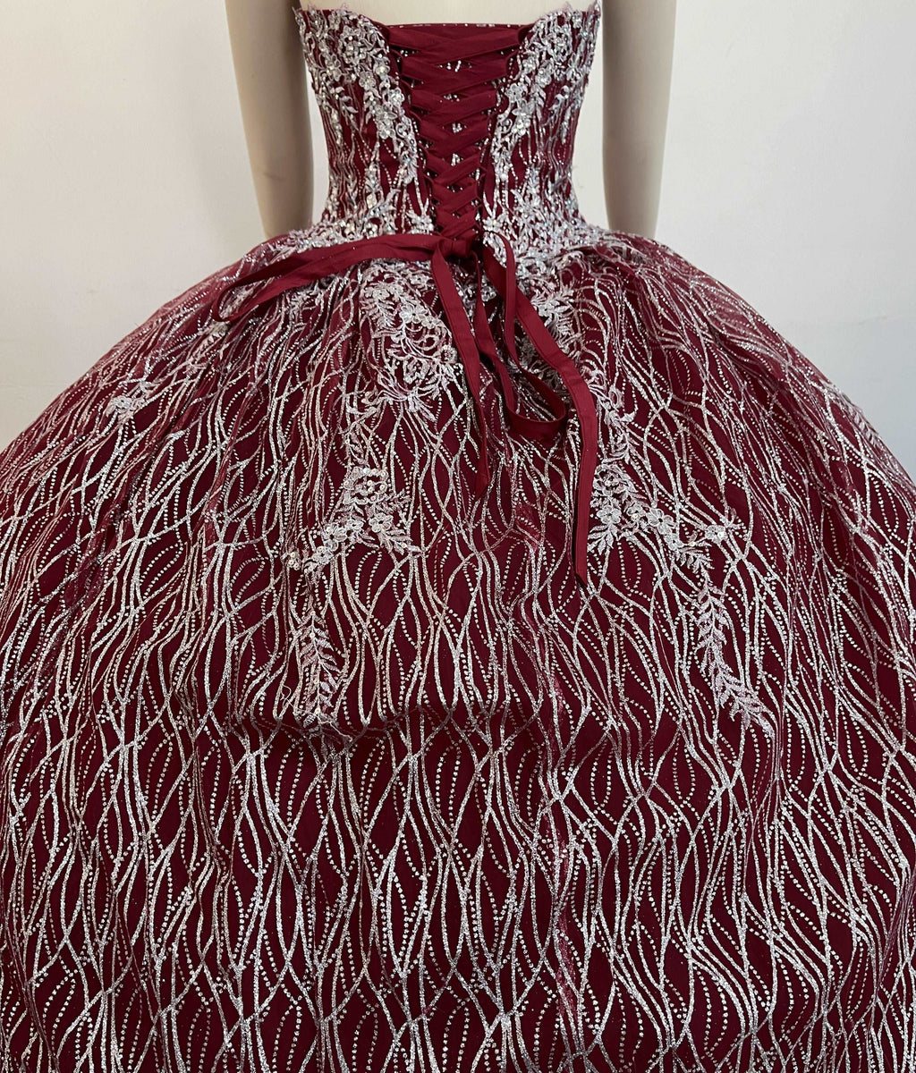 A beautiful gown, off-shoulder, reveals noble air.