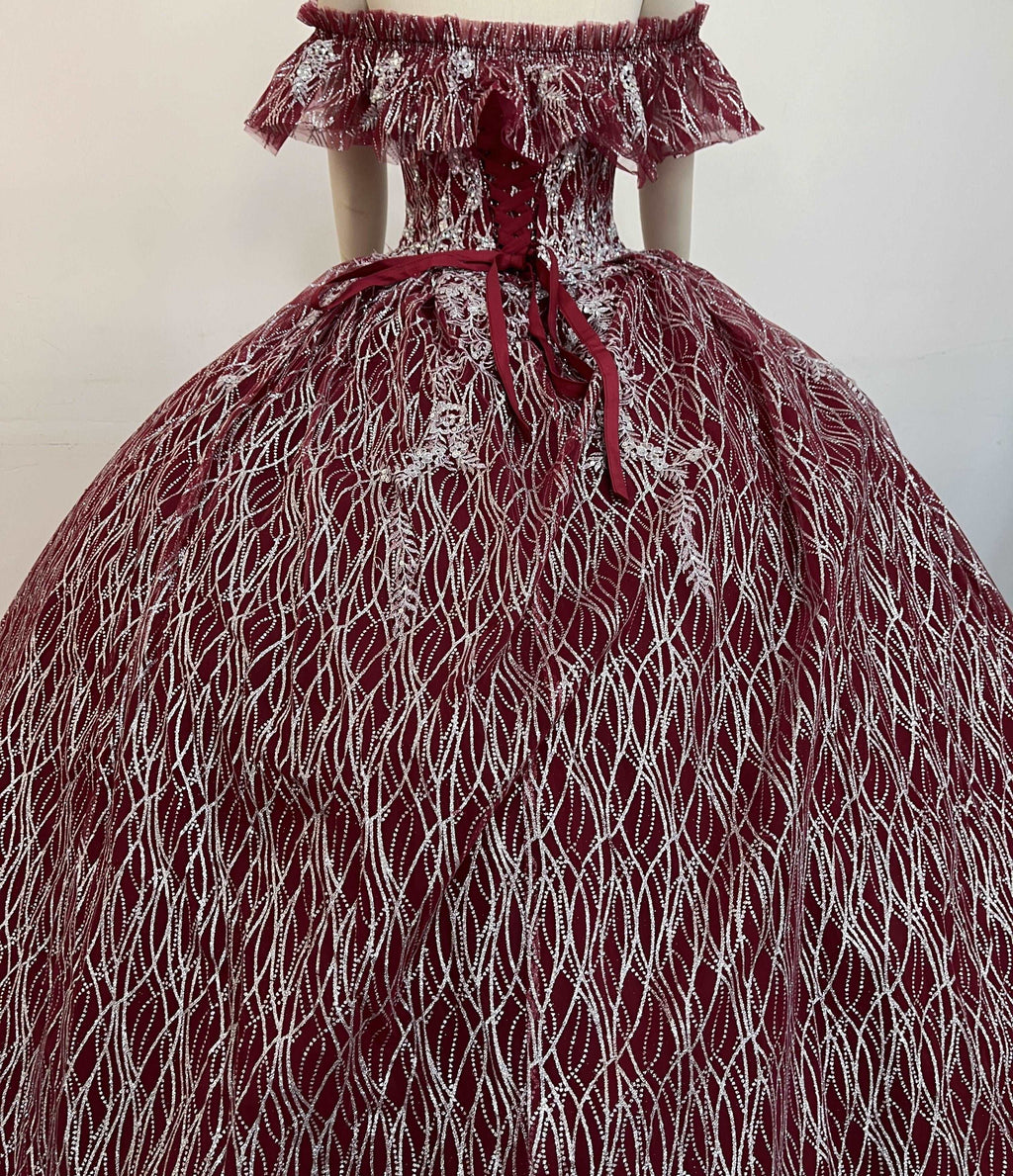 A beautiful gown, off-shoulder, reveals noble air.