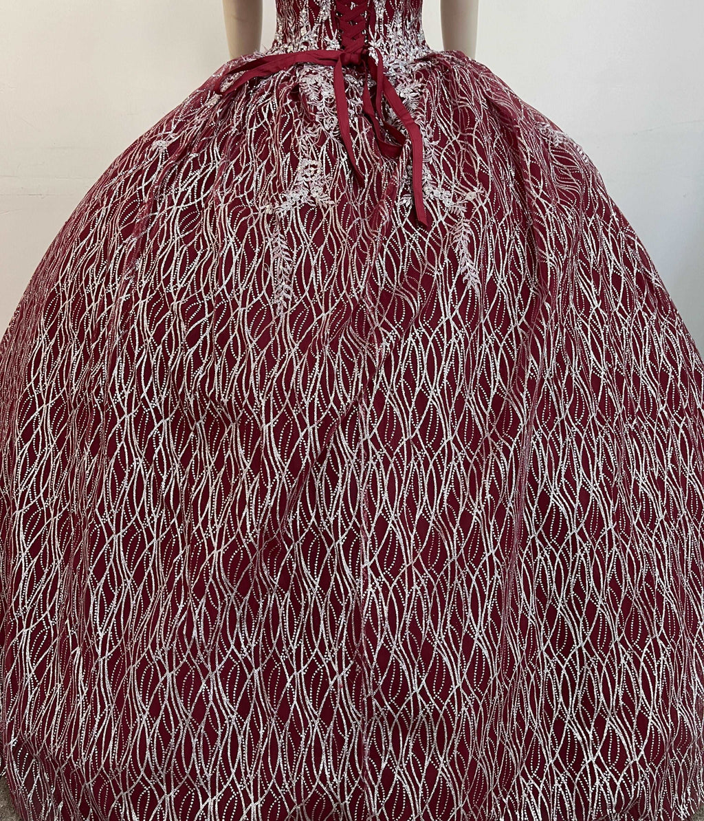 A beautiful gown, off-shoulder, reveals noble air.